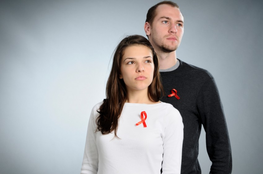 Man and a woman with AIDS awareness ribbons