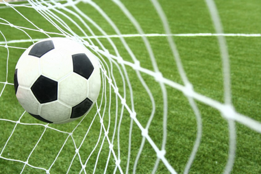 Football flying into a net