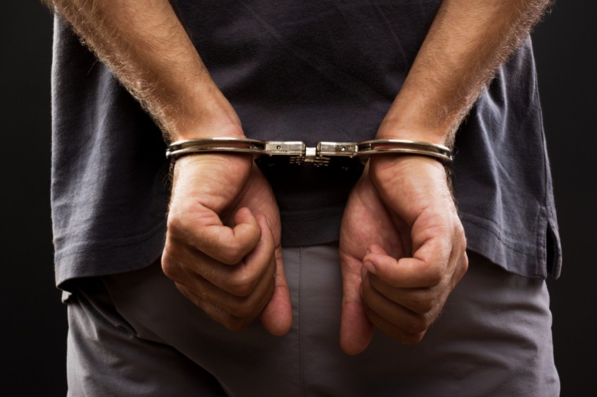man with handcuffs behind his back