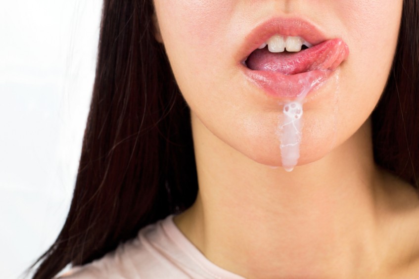 A woman has milk dripping from her mouth like semen