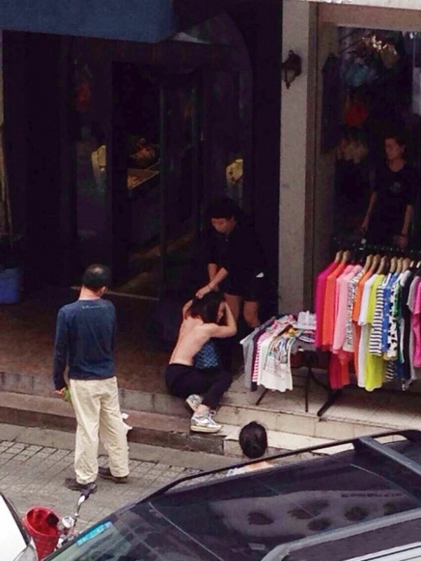 Woman being stripped naked