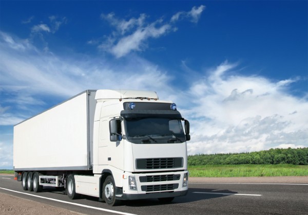 white lorry going down the road
