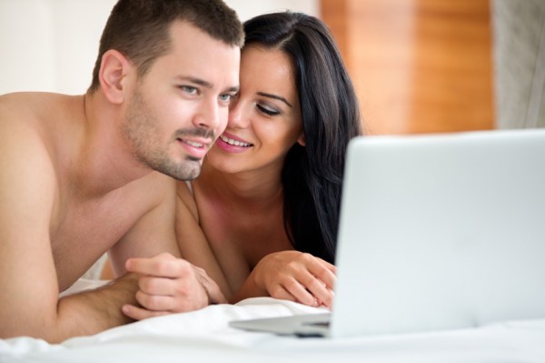 Man and woman look at a laptop