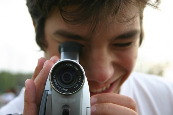 smiling mad with video camera