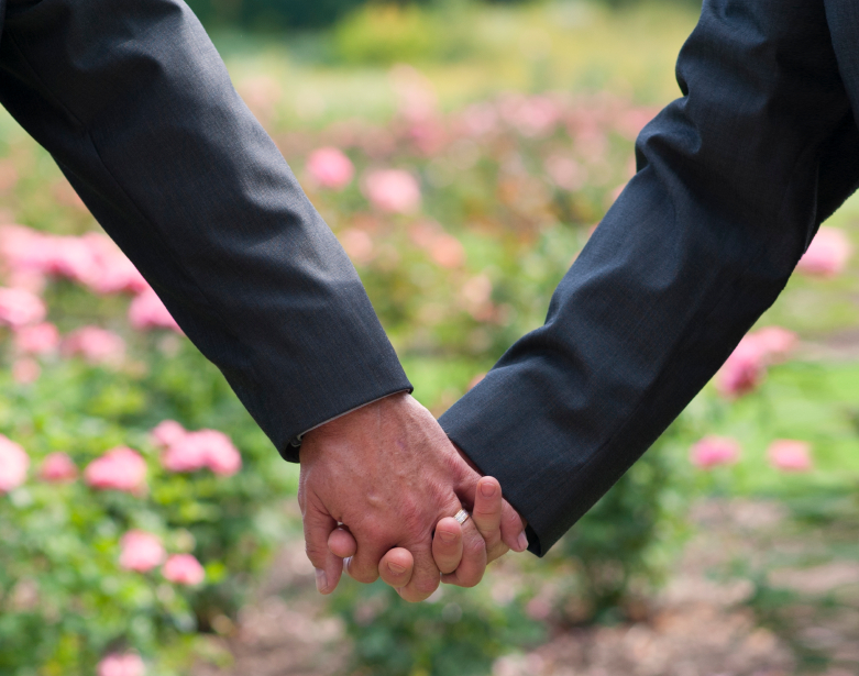 Two men holding hands