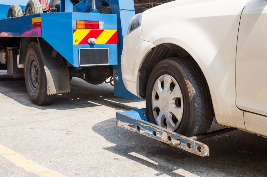 A tow truck towing a car away