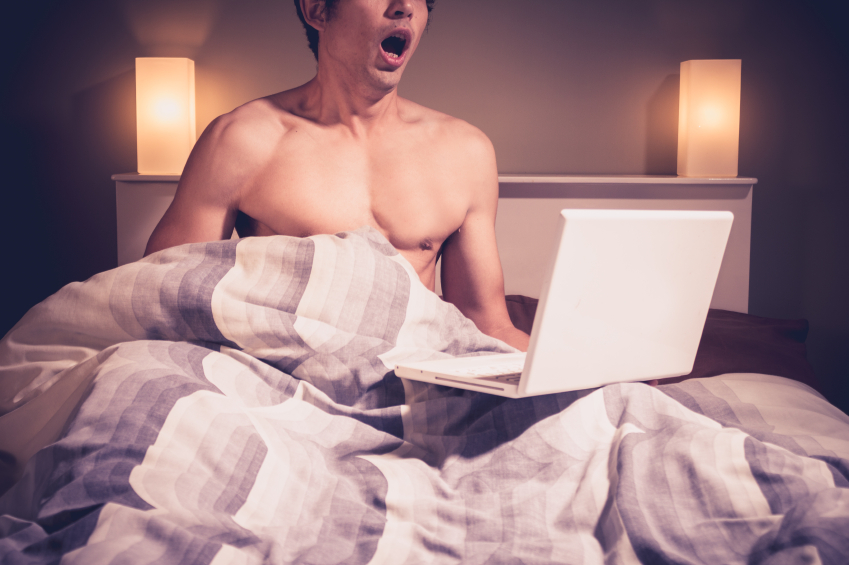 Man masturbating to laptop under bed