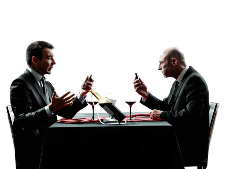 Two businessmen using phones