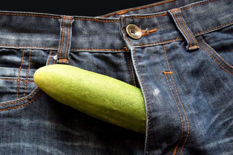 Man with cucumber coming out of his pants like a penis