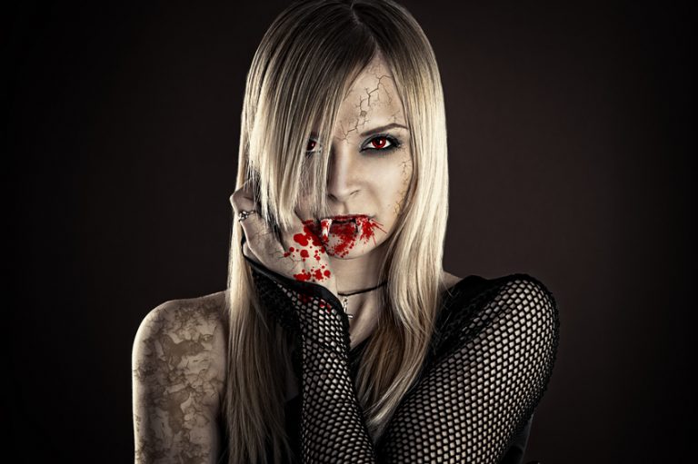 beautiful sexy vampire woman isolated on black background