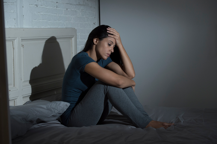 Unhappy woman on bed