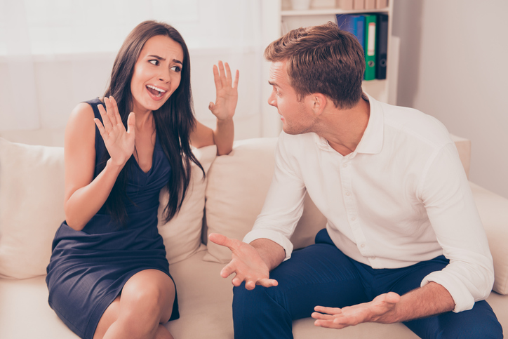 aggressive man with woman on the couch