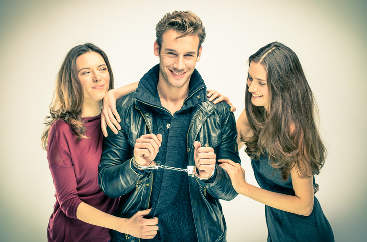 Man handcuffed by two women