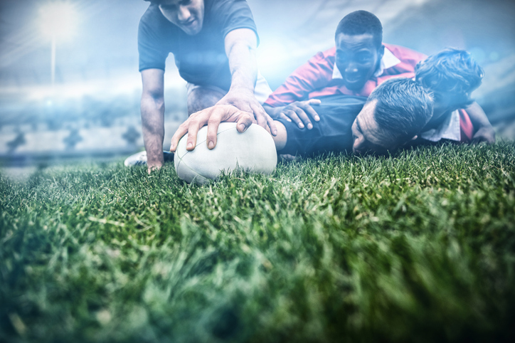 Men playing rugby