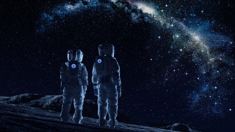 Crew of Two Astronauts in Space Suits Standing on the Moon Looking at the The Milky Way Galaxy. High Tech Concept of Moon Colonization and Space Travel.
