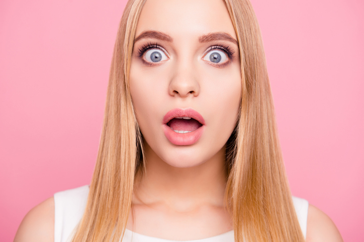 shocked woman on pink background