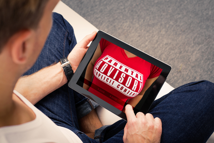 Man looking at adults website on tablet