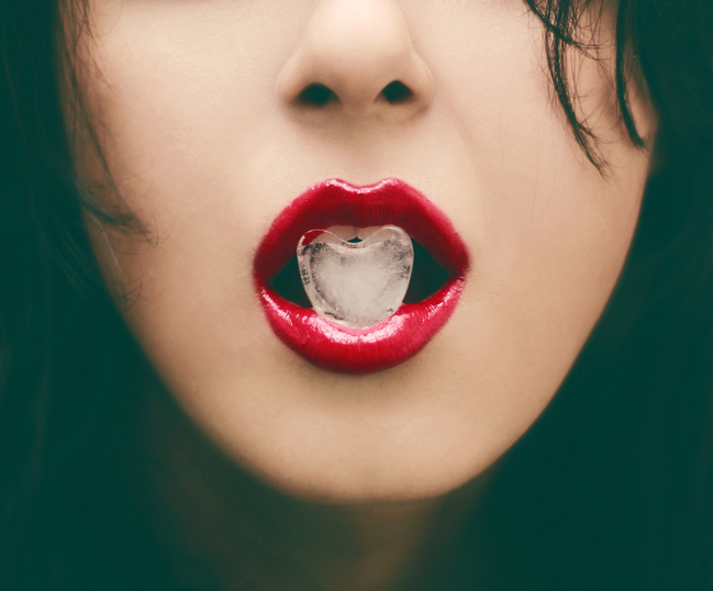 Glamour Portrait - Red Lip holding heart shape ice - Closeup