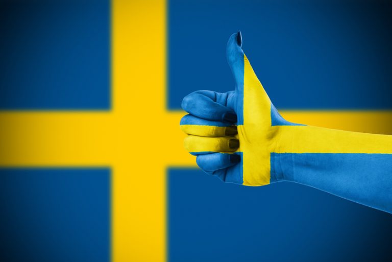 A thumbs up in front of the Swedish flag, approving of Sweden's favourite porn