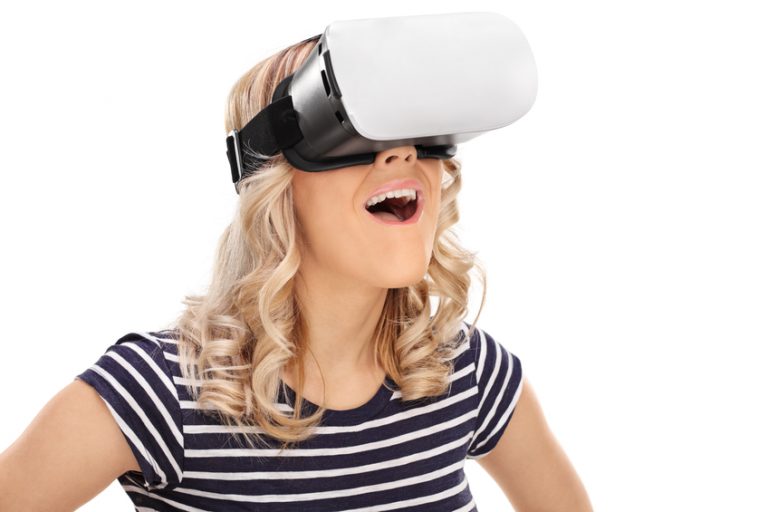 A woman uses a virtual reality headset to experience VR sex