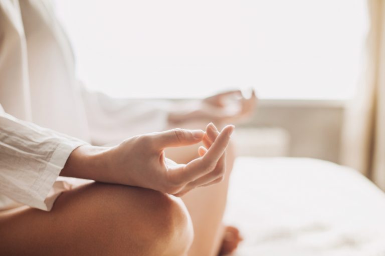 A woman meditating to follow her religious beliefs