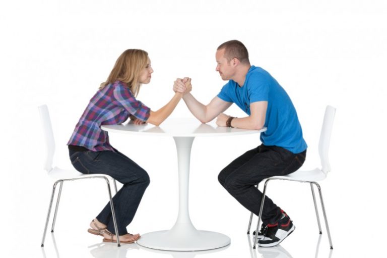 Man and woman in an arm wrestling match