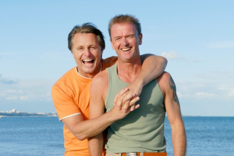 Happy gay couple on the beach