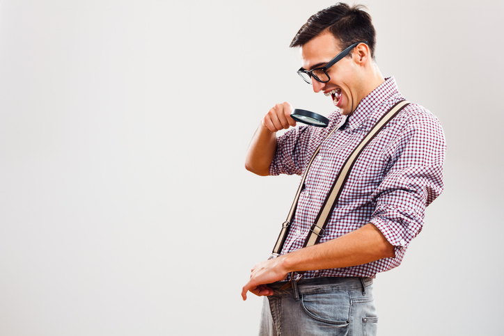 Man looks down his pants with a microscope