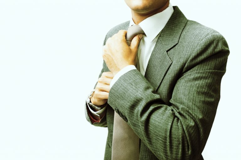 Man straightening his tie