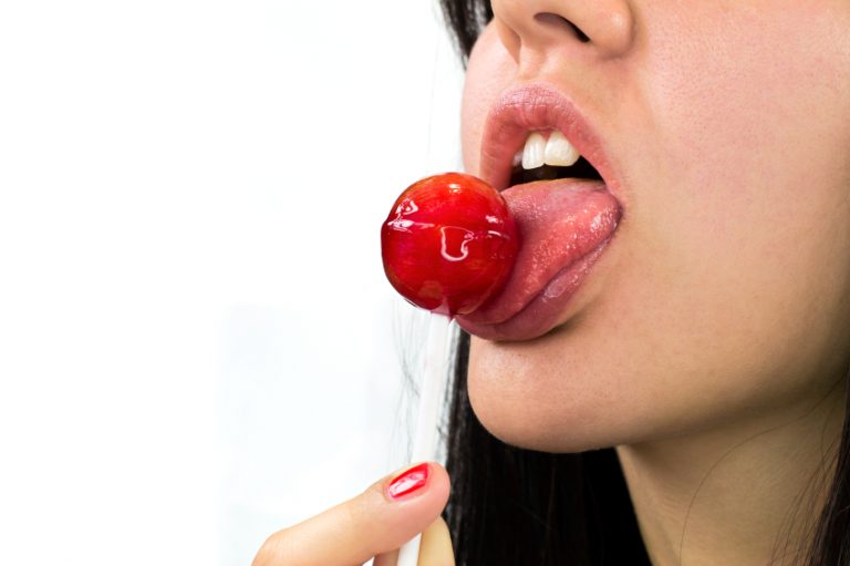 Woman licking lollipop