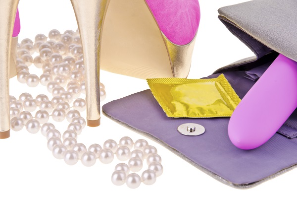 Sex toy spilling out of a handbag