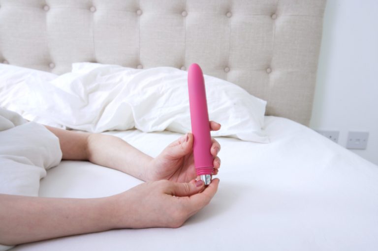 A woman in bed enjoying a little masturbation