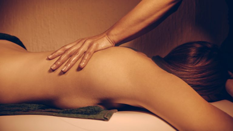 Young Woman Receiving Back Massage At Spa