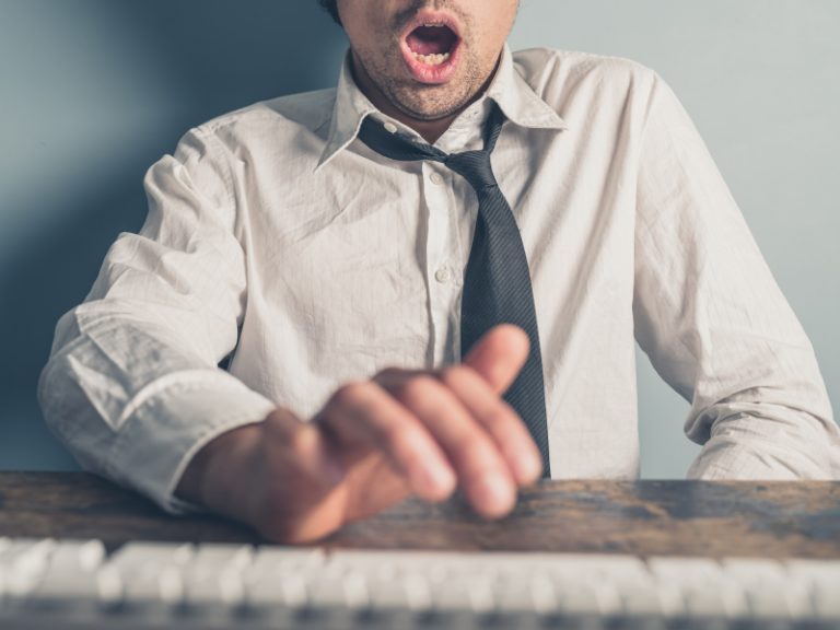 Young man jerking off over a keyboard