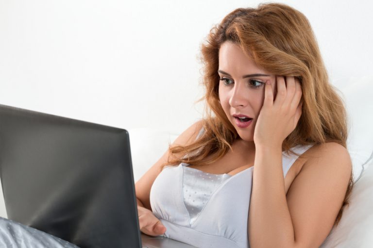 Woman looking at some strange sex accessories on her computer