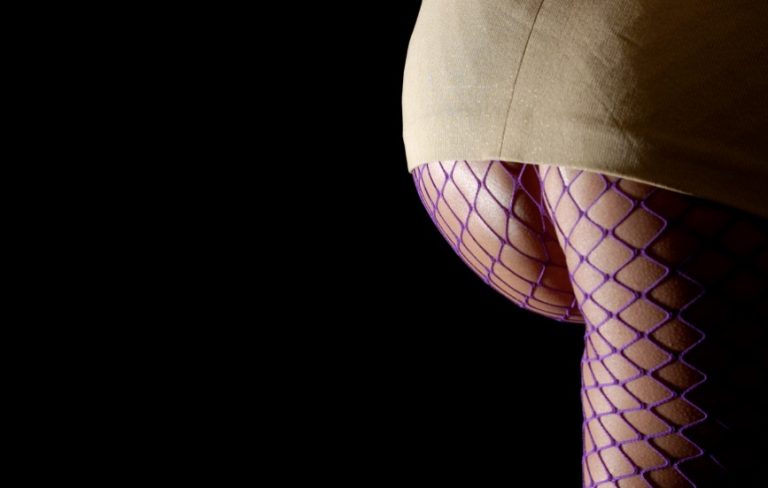 Woman's bottom in fishnet tights